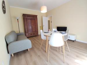 a living room with a table and chairs and a couch at casa marina in Pettenasco