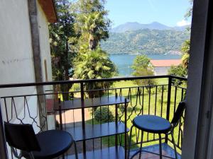 a balcony with two chairs and a view of the water at casa marina in Pettenasco