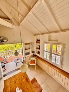 a living room with a table and a balcony at Orient Bay charming in Saint Martin