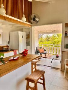 a kitchen with a counter and a table with chairs at Orient Bay charming in Saint Martin