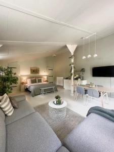 a living room with a couch and a table at Zen appartement in Vries