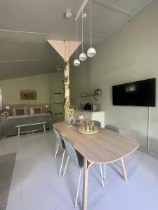 a living room with a wooden table and a couch at Zen appartement in Vries +3 photos