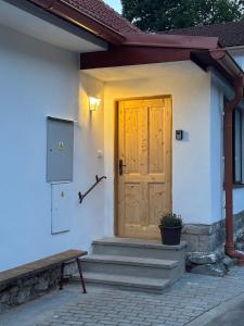 a wooden door on the side of a house at BrezINNa - 200 let historie - moderní chalupa in Počátky