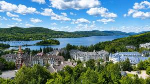 a view of a town with a lake and mountains at Tremblant Prestige - Altitude 170-9 in Mont-Tremblant