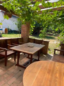 a wooden picnic table and chairs on a patio at Ubytování Adina in Velké Pavlovice