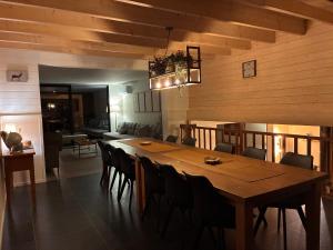 a dining room with a large wooden table and chairs at MontHuit in Houffalize