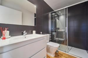 a bathroom with a white sink and a toilet at Views and Beds in Pontevedra +89 photos