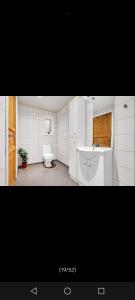 a bathroom with a toilet and a sink at Grefstadvigveien 12 in Grimstad