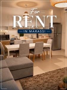 a kitchen and dining room with a table and chairs at Chalet with garden-marassi marina 2- Pool View in El Alamein