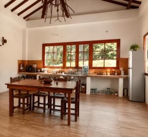 a kitchen with a table and chairs and a refrigerator at Casa de Teja Barichara in Barichara