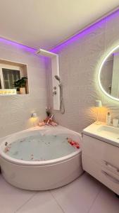 a white bathroom with a tub and a sink at Ocean Soul Apartment in Santa Cruz de Tenerife +18 photos