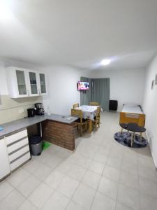 a room with a kitchen and a dining room with tables at WB1c in Puerto Madryn