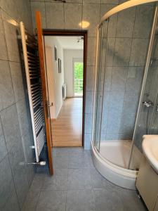 a bathroom with a shower and a tub and a sink at Kuća za odmor NIMA in Gospić +39 photos