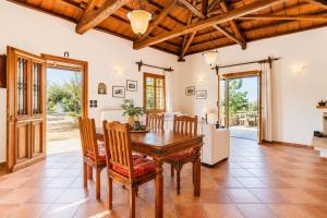 a kitchen and dining room with a wooden table and chairs at Villa Ioanna in Skopelos Town