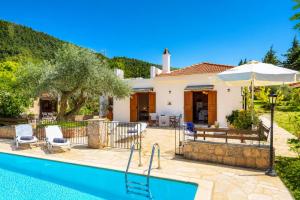 a villa with a swimming pool and a house at Villa Ioanna in Skopelos Town