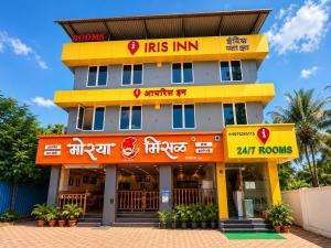 a hotel with a yellow and orange building at Hotel Iris Inn - Near Lodha Palava, Dombivali in Dombivli