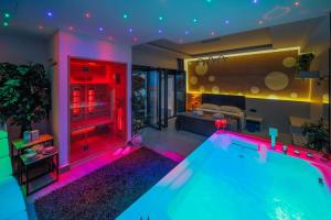 a living room with a swimming pool with purple lights at Suite Apartment Taormina in Taormina
