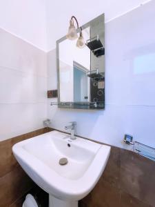 a bathroom with a white sink and a mirror at Tea Pick View Ella in Ella +80 photos