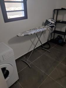 a drying rack next to a washing machine in a room at Villa Pauline in Les Abymes