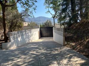 a white fence next to a walkway with trees at Casa Valley Boutique in Melegis +32 photos