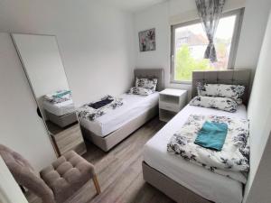 a small bedroom with two beds and a mirror at Haus,Weinberg22 in Rüsselsheim +9 photos
