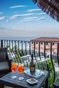 a table with two glasses and a bottle of wine at Suite Apartment Taormina in Taormina