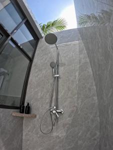 a shower with a shower head in a bathroom at Lagoon Dhigurah in Dhigurah +25 photos
