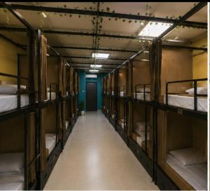 a hallway with four bunk beds in a room at GPT hostel in Hyderabad