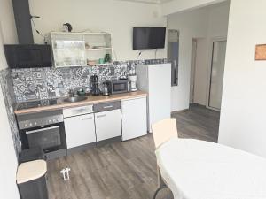 a kitchen with white cabinets and a counter top at Haus,Weinberg22 in Rüsselsheim
