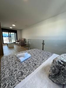 a bedroom with a large bed with a pillow on it at A&R Atico Duplex Luxury I in San Sebastián de los Reyes +73 photos