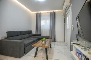 a living room with a couch and a coffee table at Ermira in Agios Nikolaos