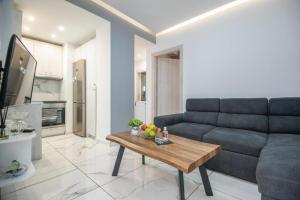 a living room with a couch and a table at Ermira in Agios Nikolaos