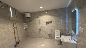 a bathroom with a shower and a toilet and a sink at الشروق in Al Baha +10 photos
