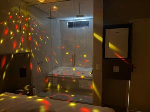 a room with a glass wall with lights in it at Wish Suítes in Campinas +21 photos