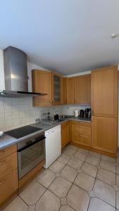 a kitchen with wooden cabinets and white appliances at Private Home in Hamburg in Hamburg