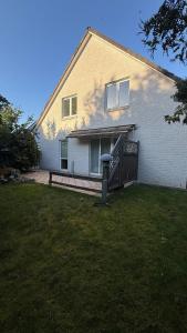 a house with a bench in front of a yard at Private Home in Hamburg in Hamburg
