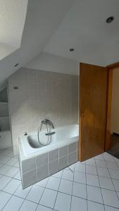 a bath tub in a bathroom with a door at Private Home in Hamburg in Hamburg +34 photos