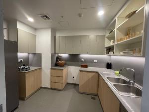 a kitchen with white cabinets and a sink at Luxury Apt l La Gare in Addis Ababa +1 photo