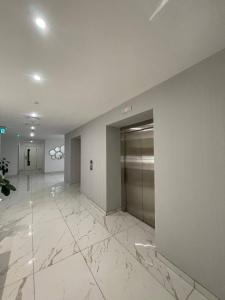 an empty lobby with a elevator in a building at Luxury Apt l La Gare in Addis Ababa