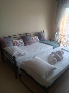 two beds in a room with towels on them at Melinas Home in Chrysoupolis