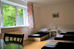 a room with two beds and a window at TanieSpanie in Legionowo