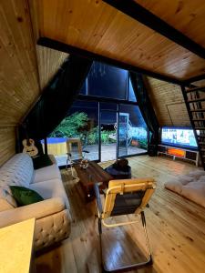 a living room with a couch and a table at Panorama Cottage in Erge