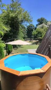 a large blue swimming pool with a wooden deck at Luna kuća- Devojački bunar in Novi Vladimirovac