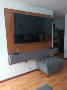 a large flat screen tv hanging on a wall at Yanahuara Urb Ibargüen in Arequipa +5 photos