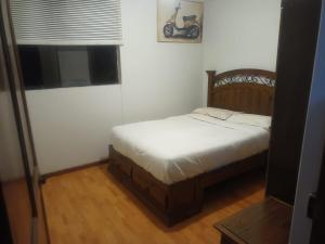 a bedroom with a bed and a motorcycle on the wall at Yanahuara Urb Ibargüen in Arequipa