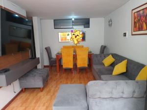 a living room with a couch and a table at Yanahuara Urb Ibargüen in Arequipa