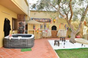 a room with a bath tub next to a building at Hacienda Oliva in Hammam Sousse