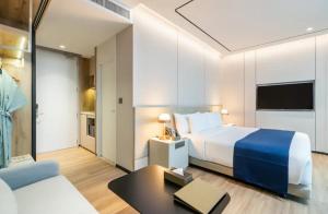 a hotel room with a bed and a couch at The- Luxury Enclave Plaza Near IGI Airport Delhi in New Delhi