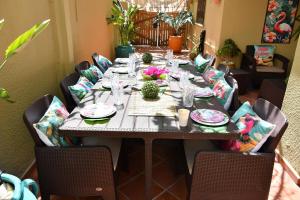 a long table with plates and glasses on it at Hacienda Oliva in Hammam Sousse