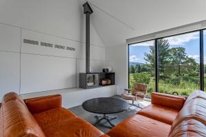 a living room with a couch and a table at Valley View - Renovated Cottage New Addon and Pool in Copake